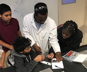 Four students working together on a science project