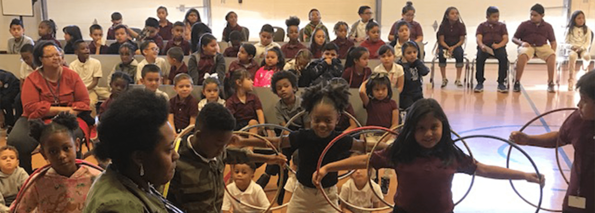 Group of students participating in a hula hoop activity