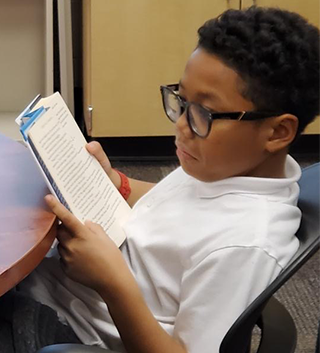 Male student reading a book